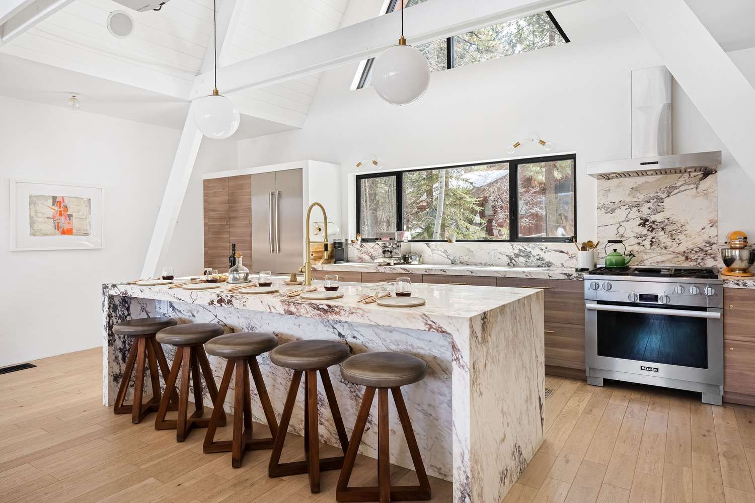 A kitchen with a large island and stools