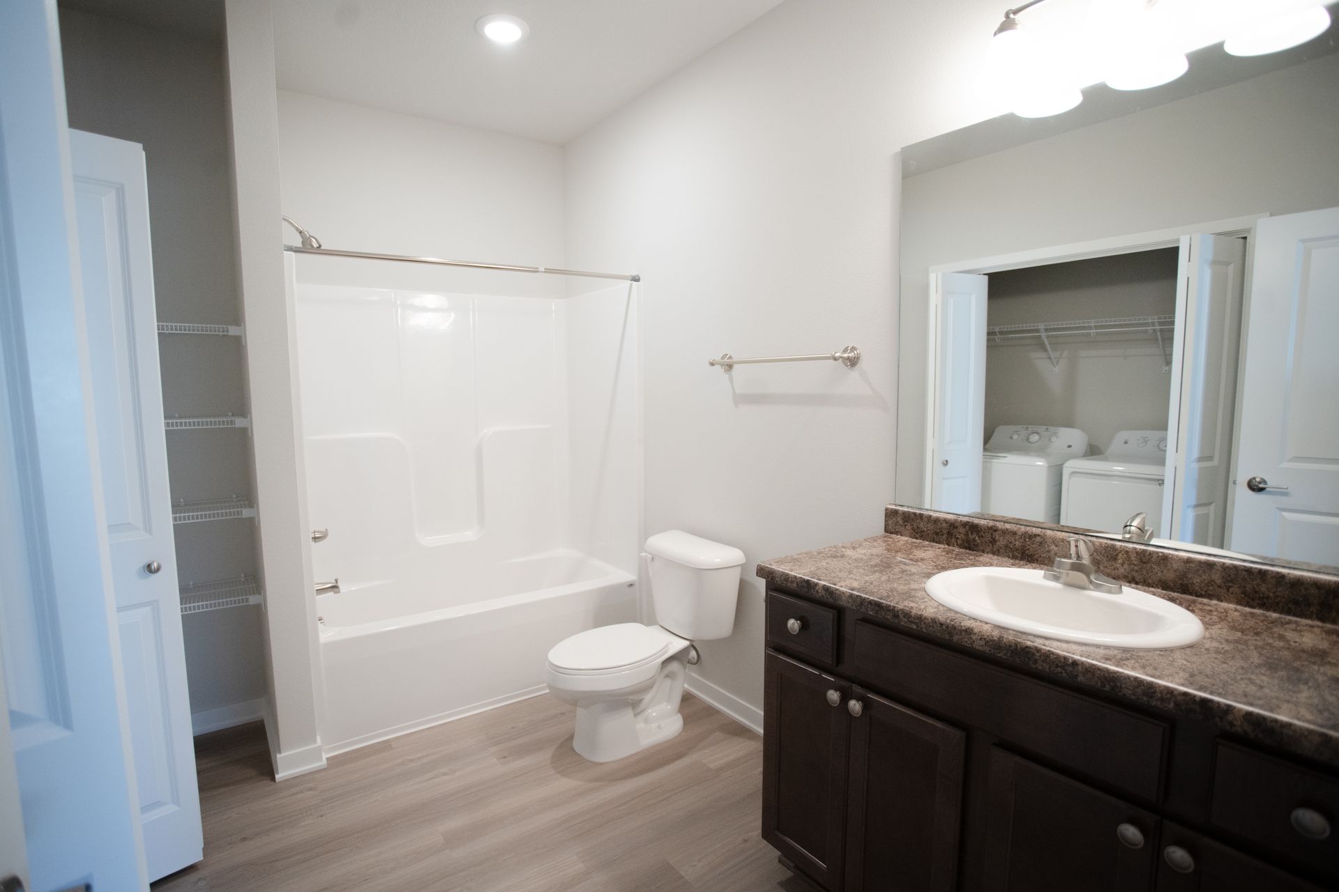 A bathroom with a toilet , sink , and bathtub.