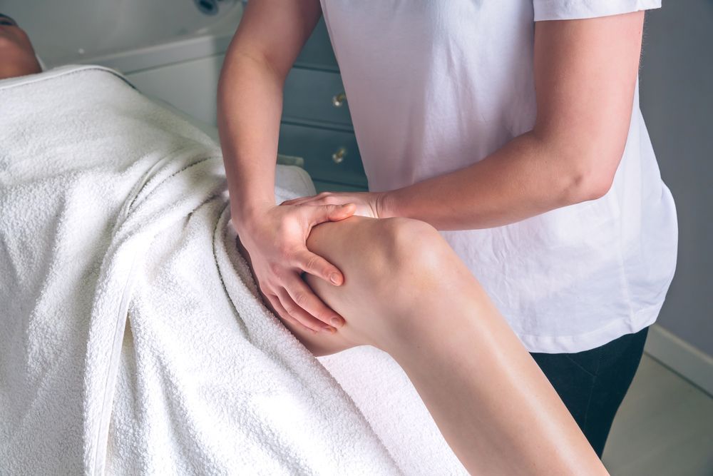 Therapist Massaging a Person's Knee on a Massage Table — A1 Coffs Harbour in Coffs Harbour, NSW