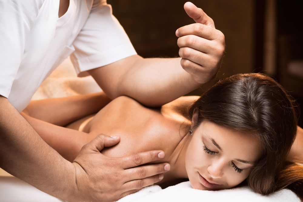 Person Receiving a Massage on Their Back in a Dimly Lit Setting — A1 Coffs Harbour in Coffs Harbour, NSW