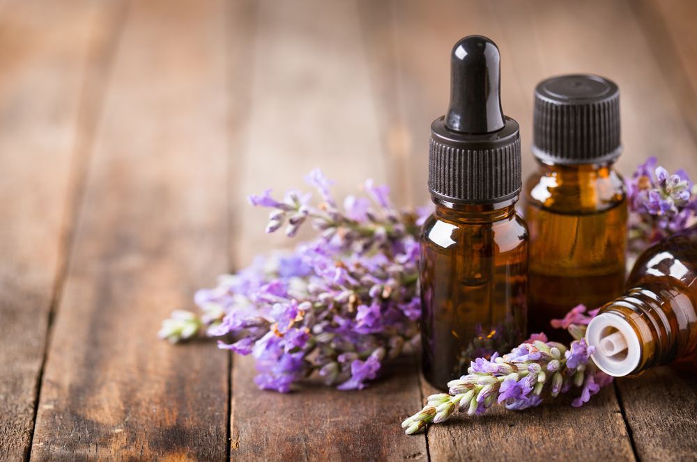 Bottles of Essential Oil With Purple Lavender Sprigs — A1 Coffs Harbour in Coffs Harbour, NSW