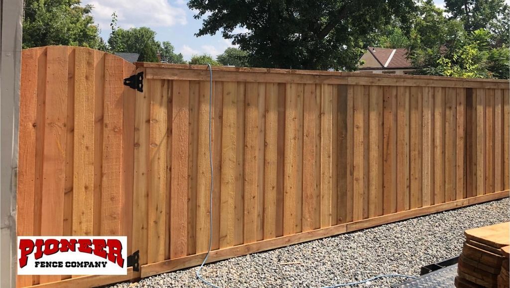 A wooden fence with the word pioneer on it