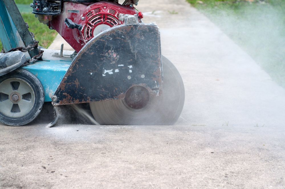 Concrete Saw Cutting a Concrete Surface, Creating Dust — Ultra Services Ground Pavement & Building in Abercrombie, NSW