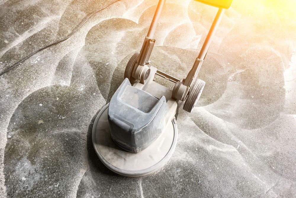 Floor Sander Grinding a Dusty Concrete Surface — Ultra Services Ground Pavement & Building in Abercrombie, NSW