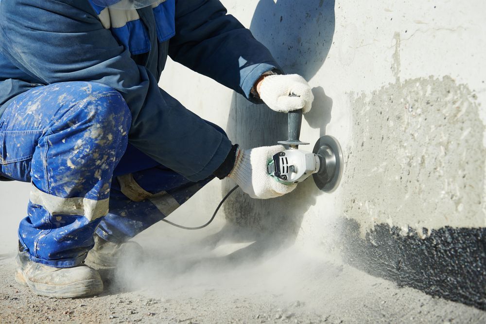 Person Grinding a Concrete Surface with Power Tool — Ultra Services Ground Pavement & Building in Forbes, NSW