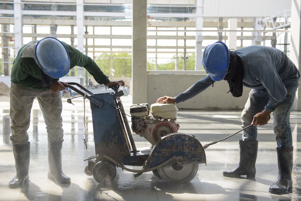 Two Construction Workers Operating a Concrete Saw — Ultra Services Ground Pavement & Building in Cobar, NSW