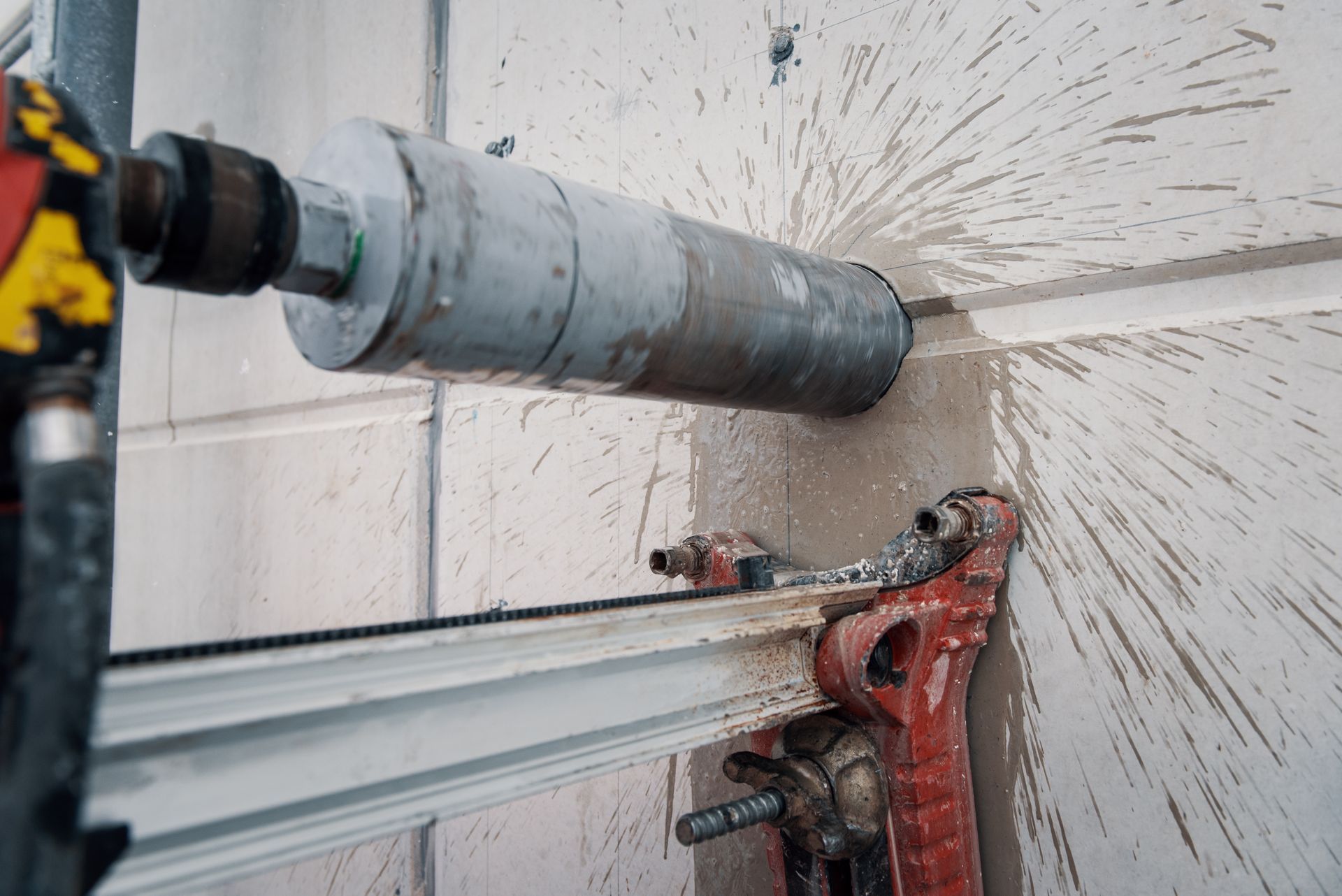 Core Drill in Use, Drilling Through a Concrete Wall — Ultra Services Ground Pavement & Building in Dubbo, NSW