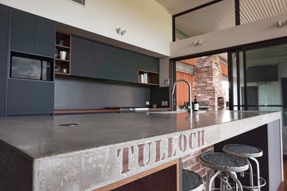A Kitchen With A Concrete Counter Top That Says Tulloch On It — Concept Design Kitchens & Joinery In Hawks Nest, NSW