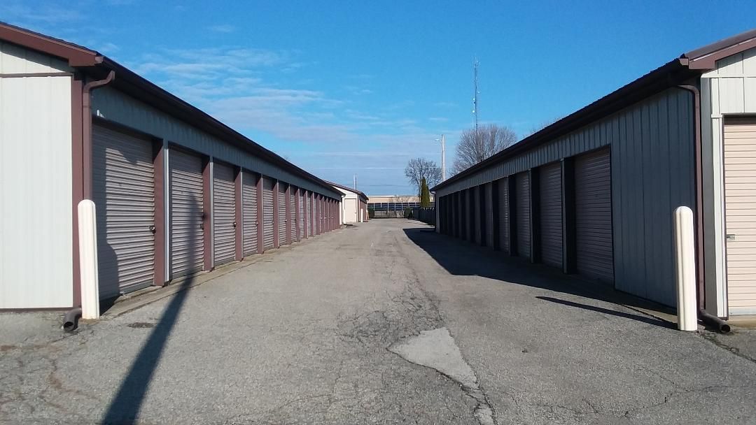 A row of storage units are lined up next to each other on a sunny day.