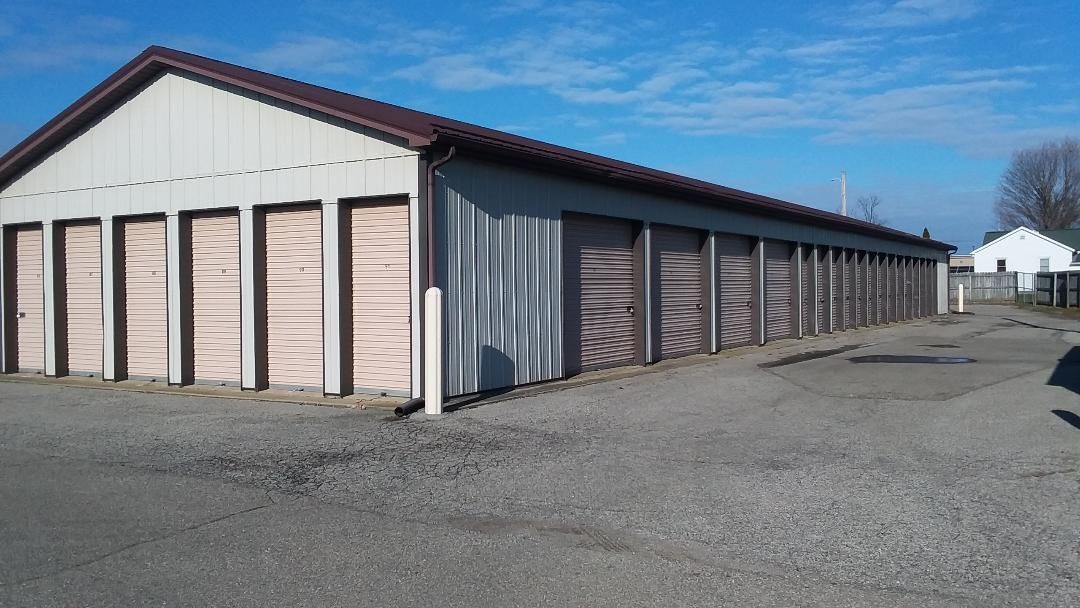 A row of garage doors are lined up in a parking lot.