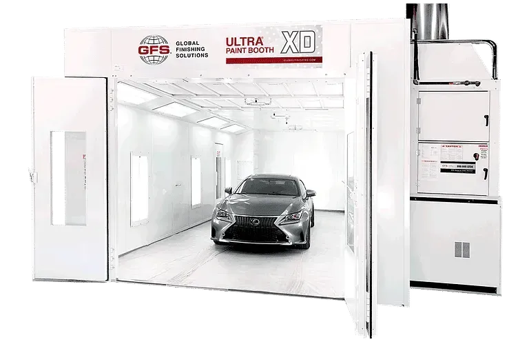 Car inside a white paint booth with open doors; signage on top right.