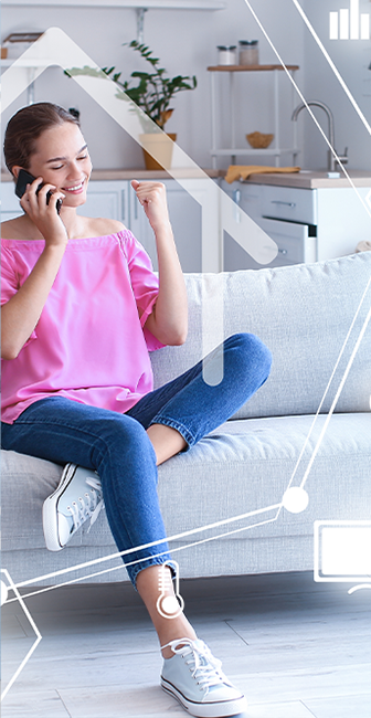 a woman is sitting on a couch talking on a cell phone .