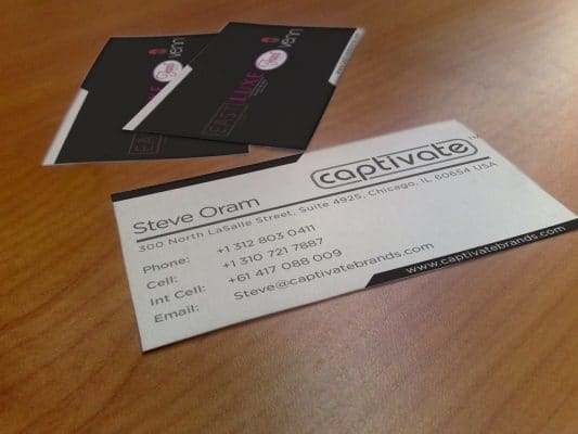 a business card for steve oram sits on a wooden table