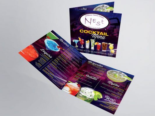 a nest cocktail menu is displayed on a table .