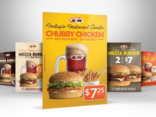 a bunch of a&w burgers and drinks are sitting on a table .