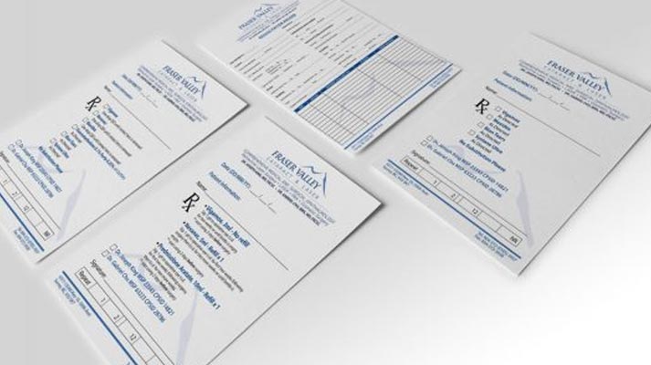 three sheets of paper with numbers on them are laying on a table .