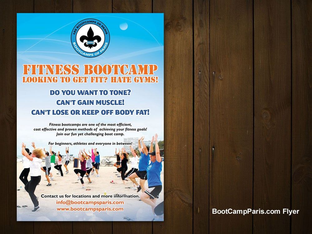 a flyer for a fitness bootcamp is on a wooden table