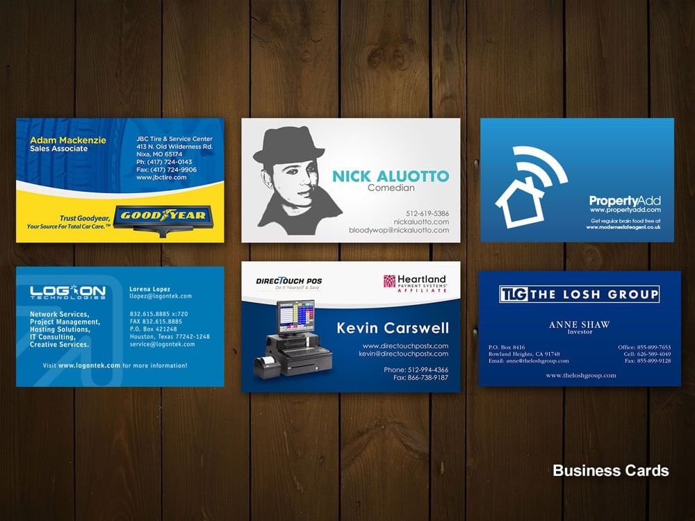 a collection of business cards on a wooden table