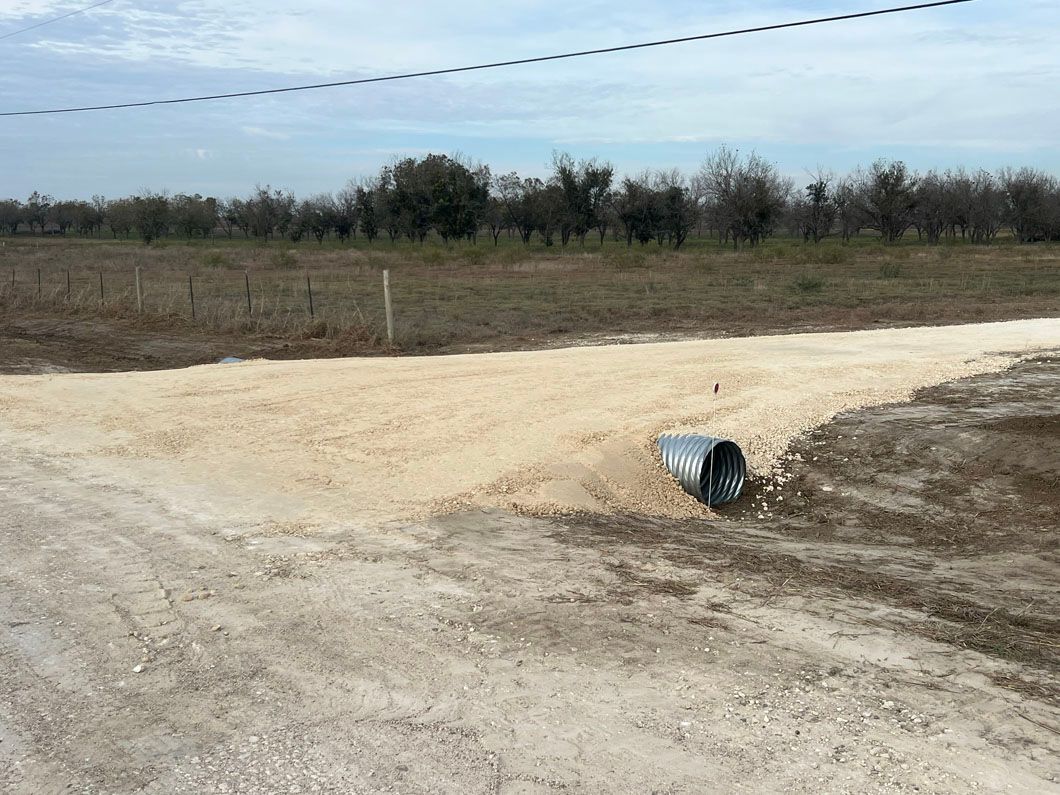A mailbox is sitting on the side of a dirt road.