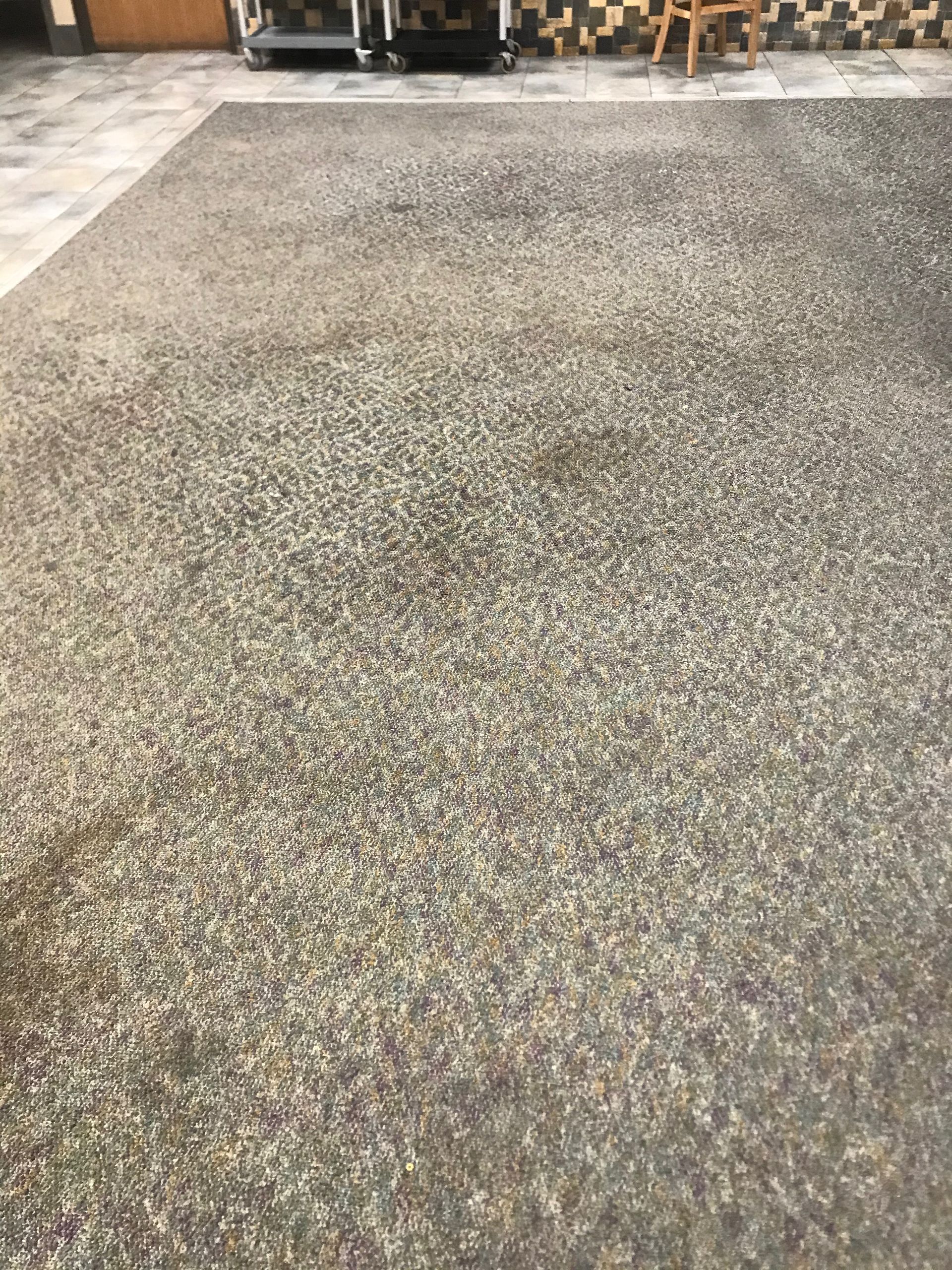 A concrete floor with a lot of small rocks on it.