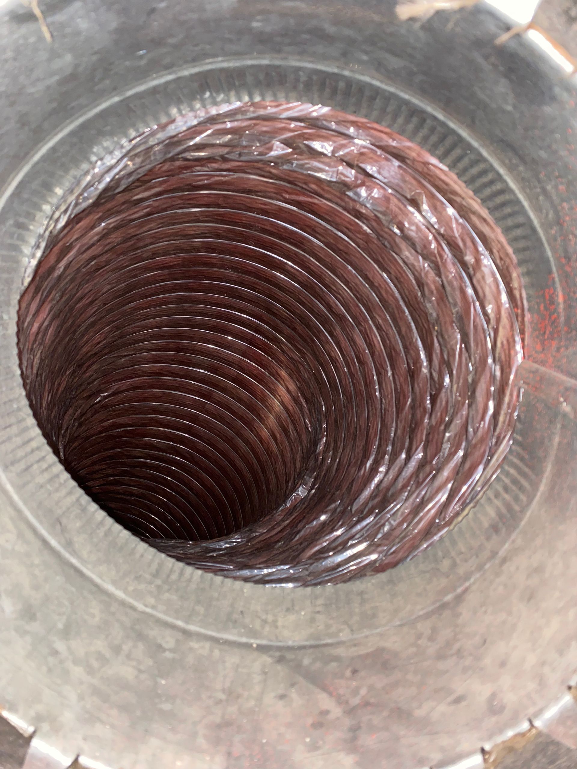 A close up of a metal pipe with a hole in the middle