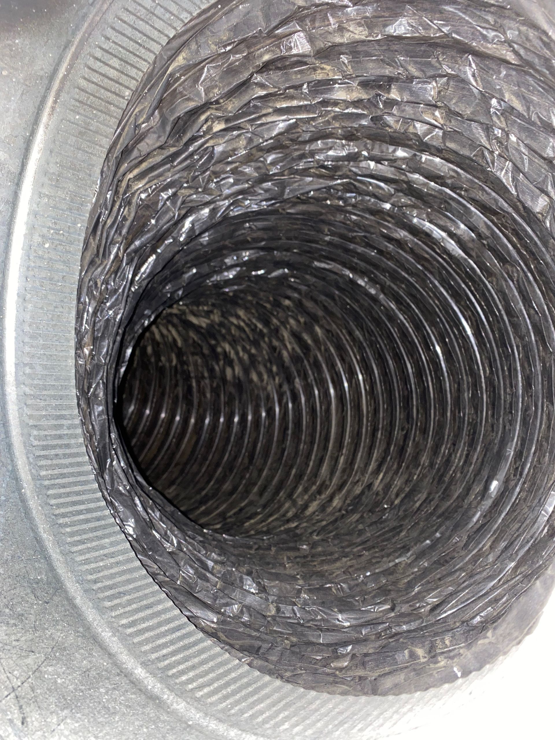 A close up of the inside of a duct on a white background.