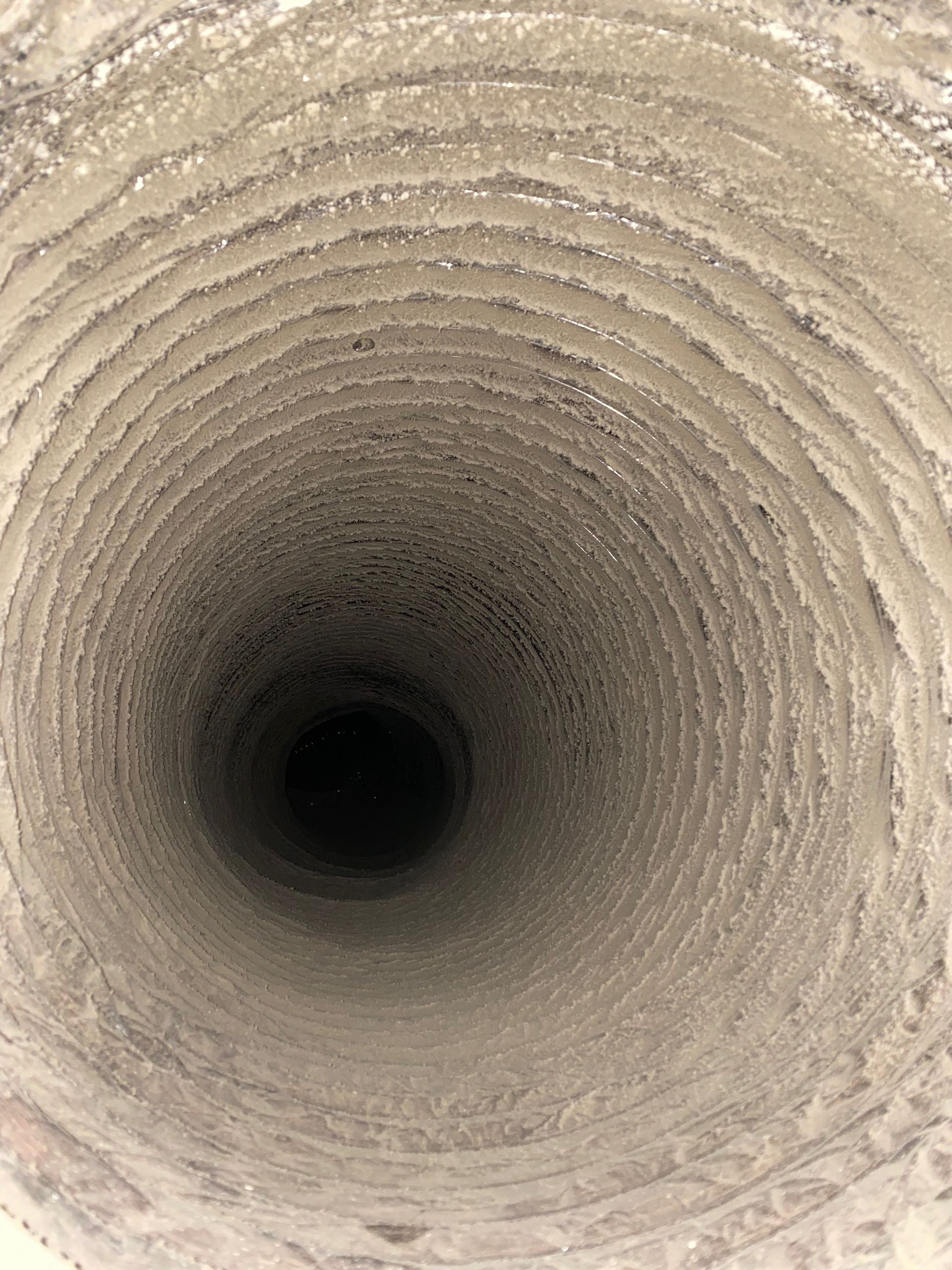 A close up of the inside of a dirty air vent.