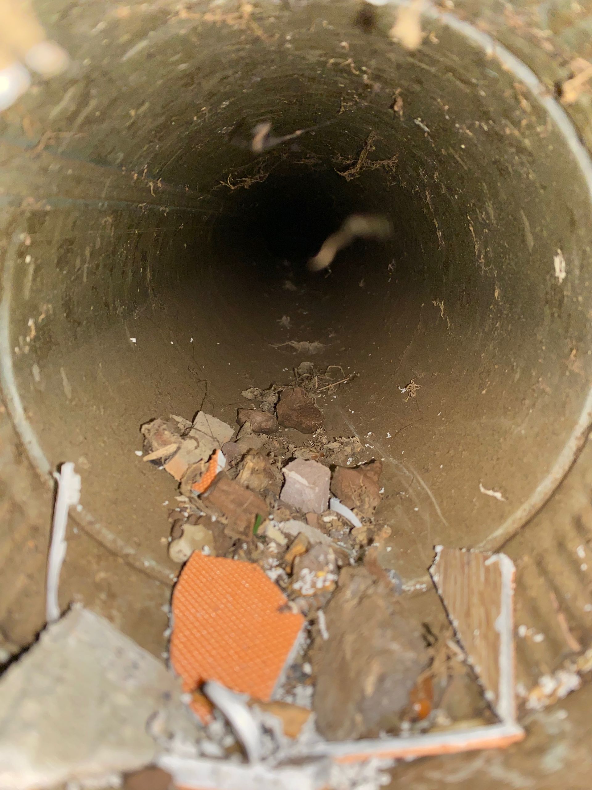 A hole in the ground filled with dirt and bricks