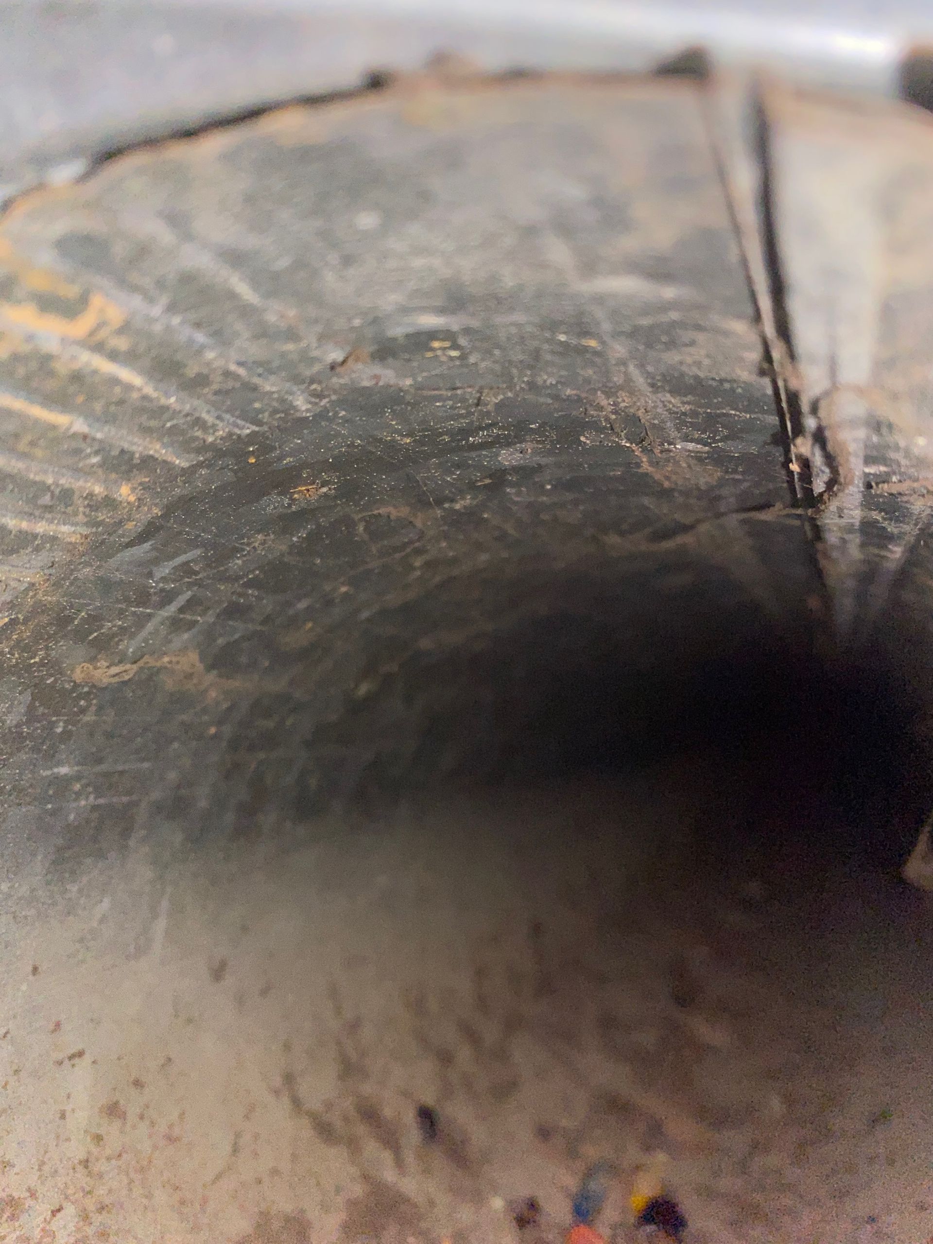 A close up of a metal pipe with a hole in the middle