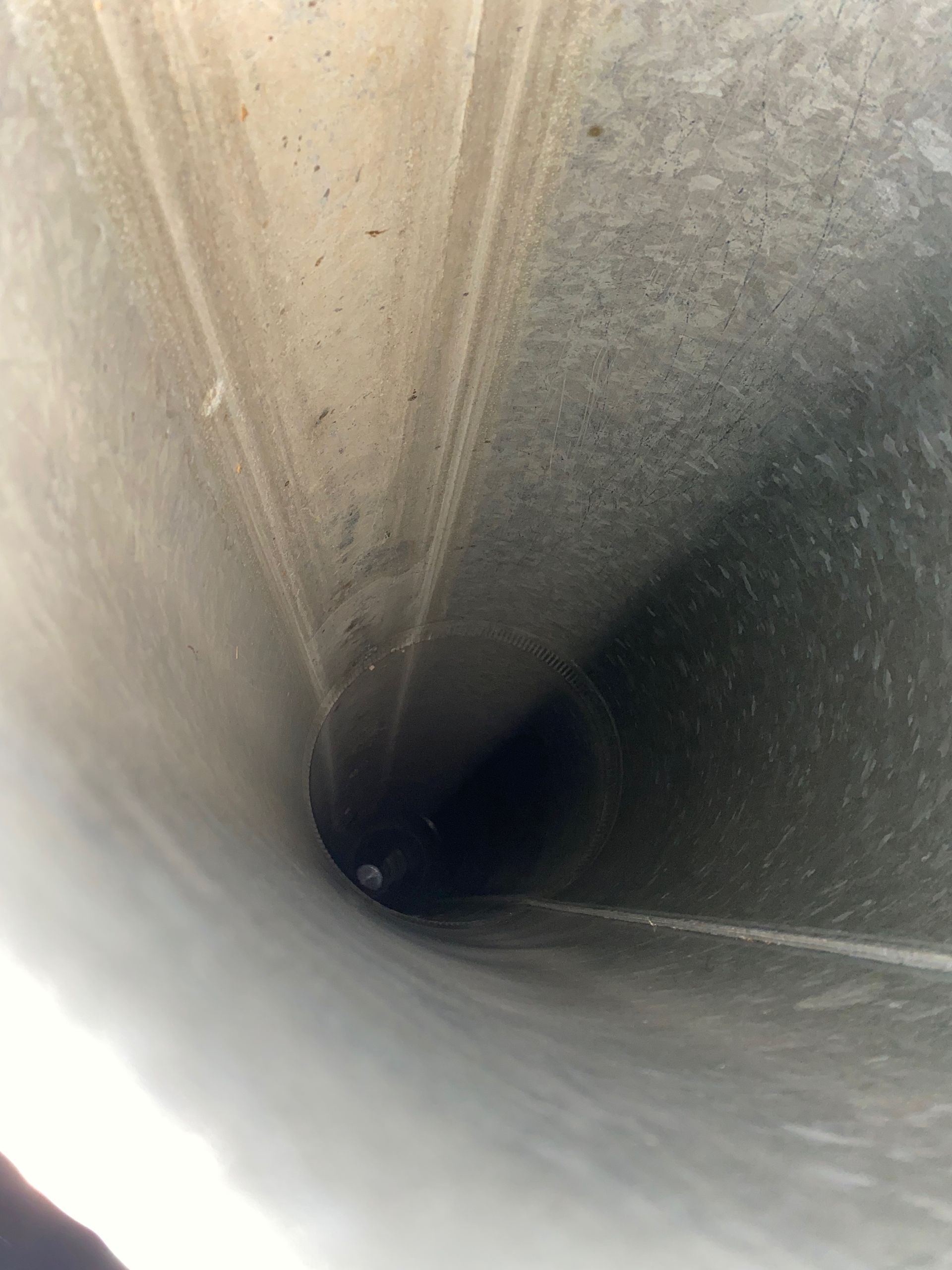 A close up of the inside of a concrete pipe.