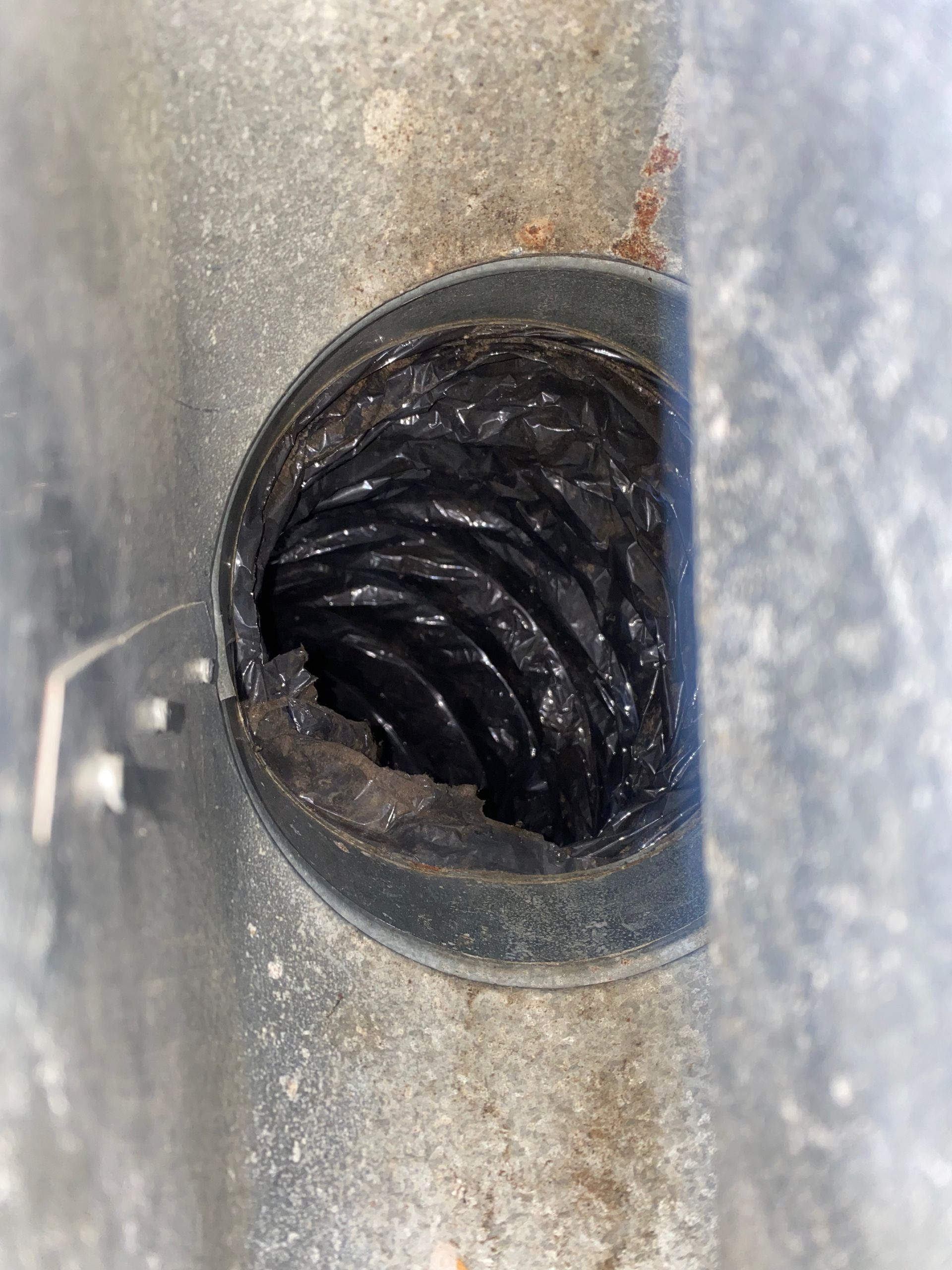 A close up of a hole in a metal pipe