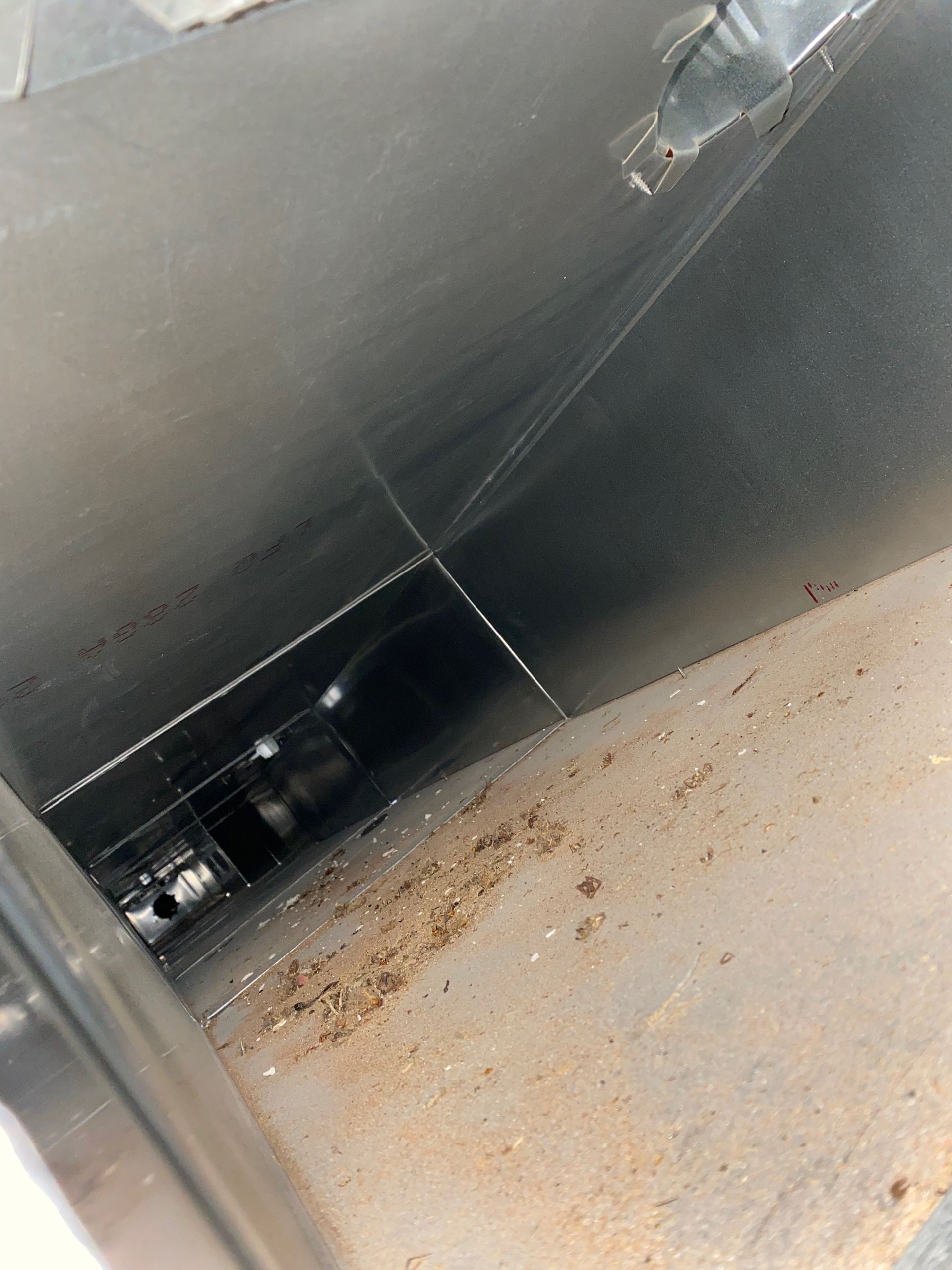 A close up of a metal pipe with a hole in it