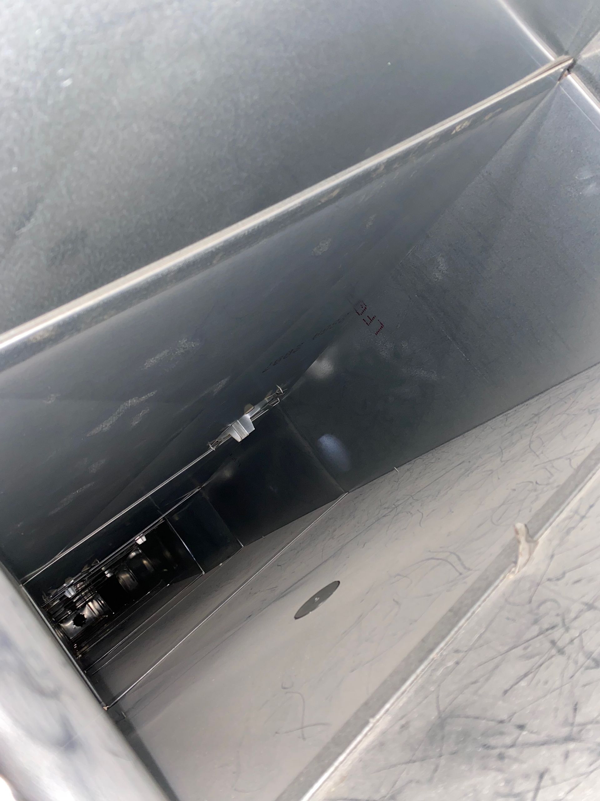 A stainless steel container with a hole in the middle