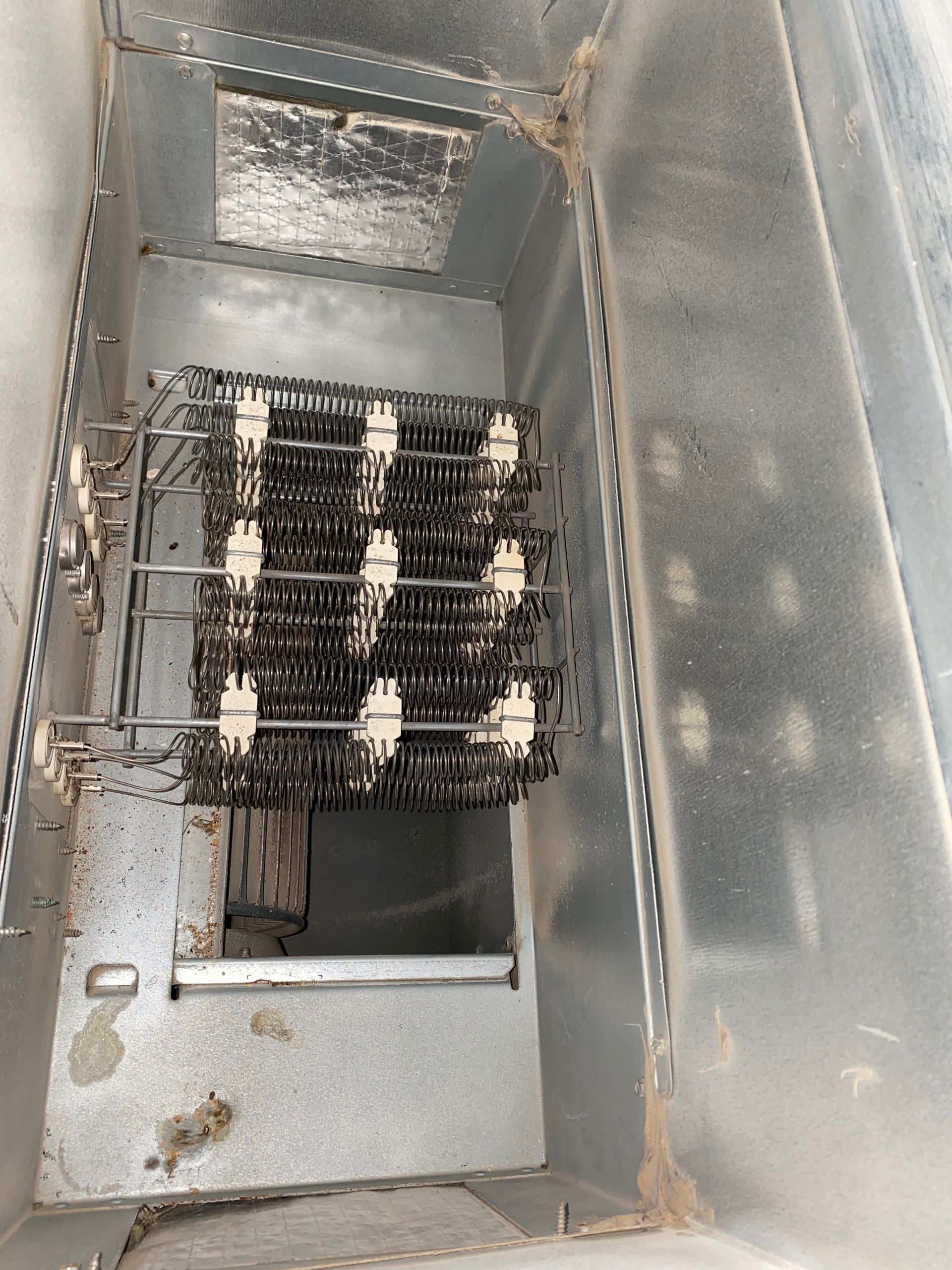 A metal container with a bunch of wires in it