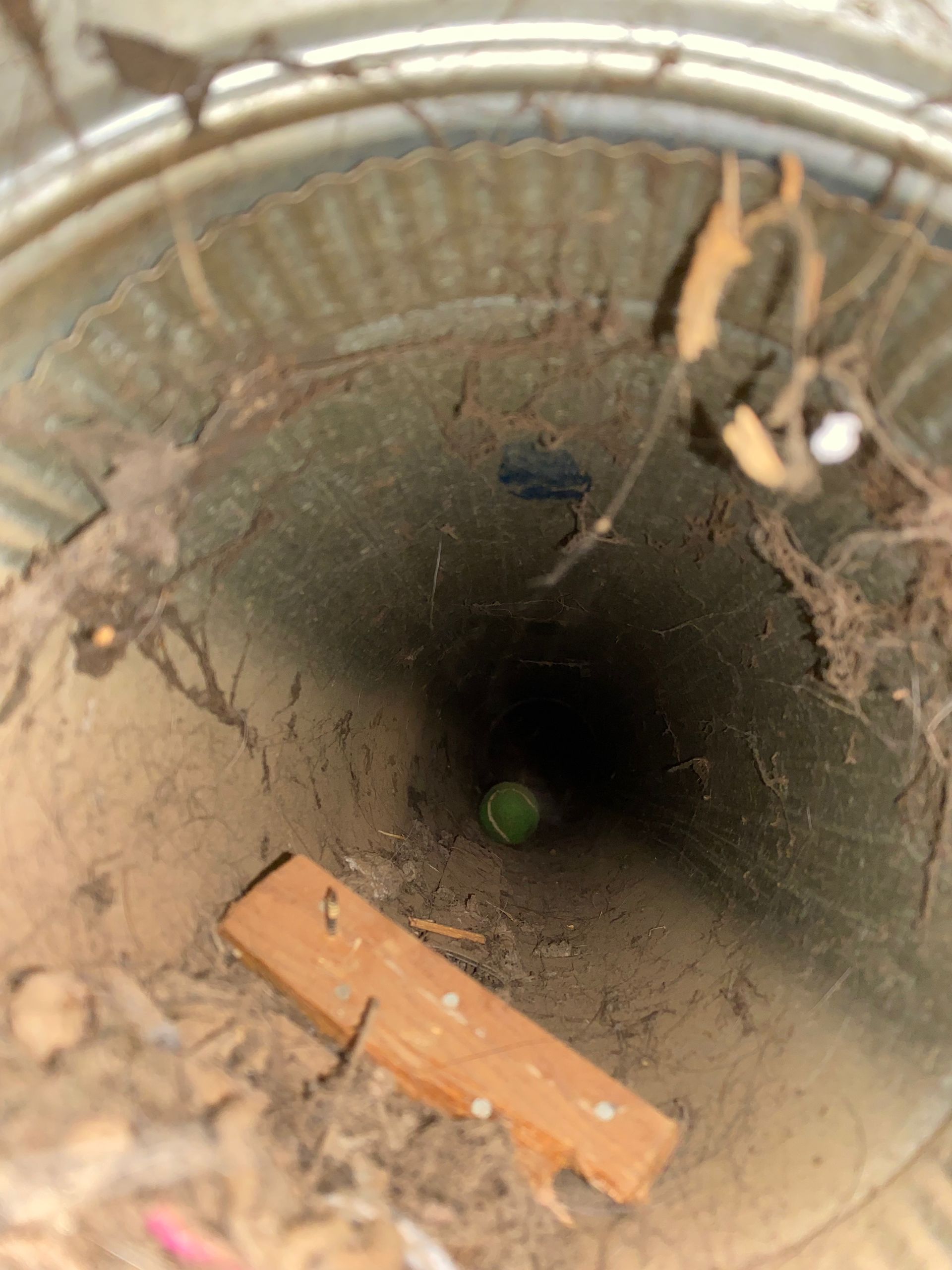 A hole in the ground with a green object in it