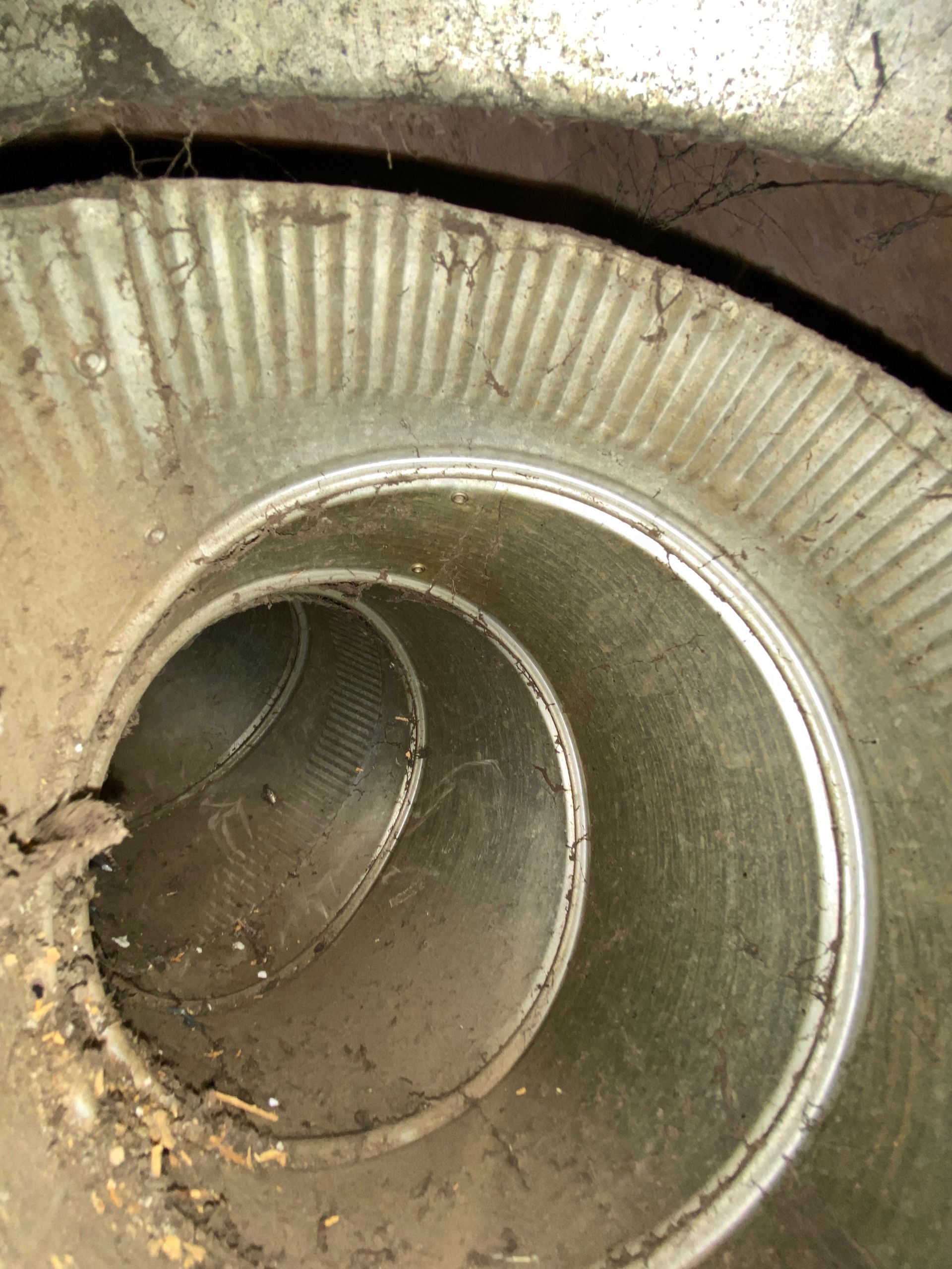 A close up of a metal pipe with a hole in the middle