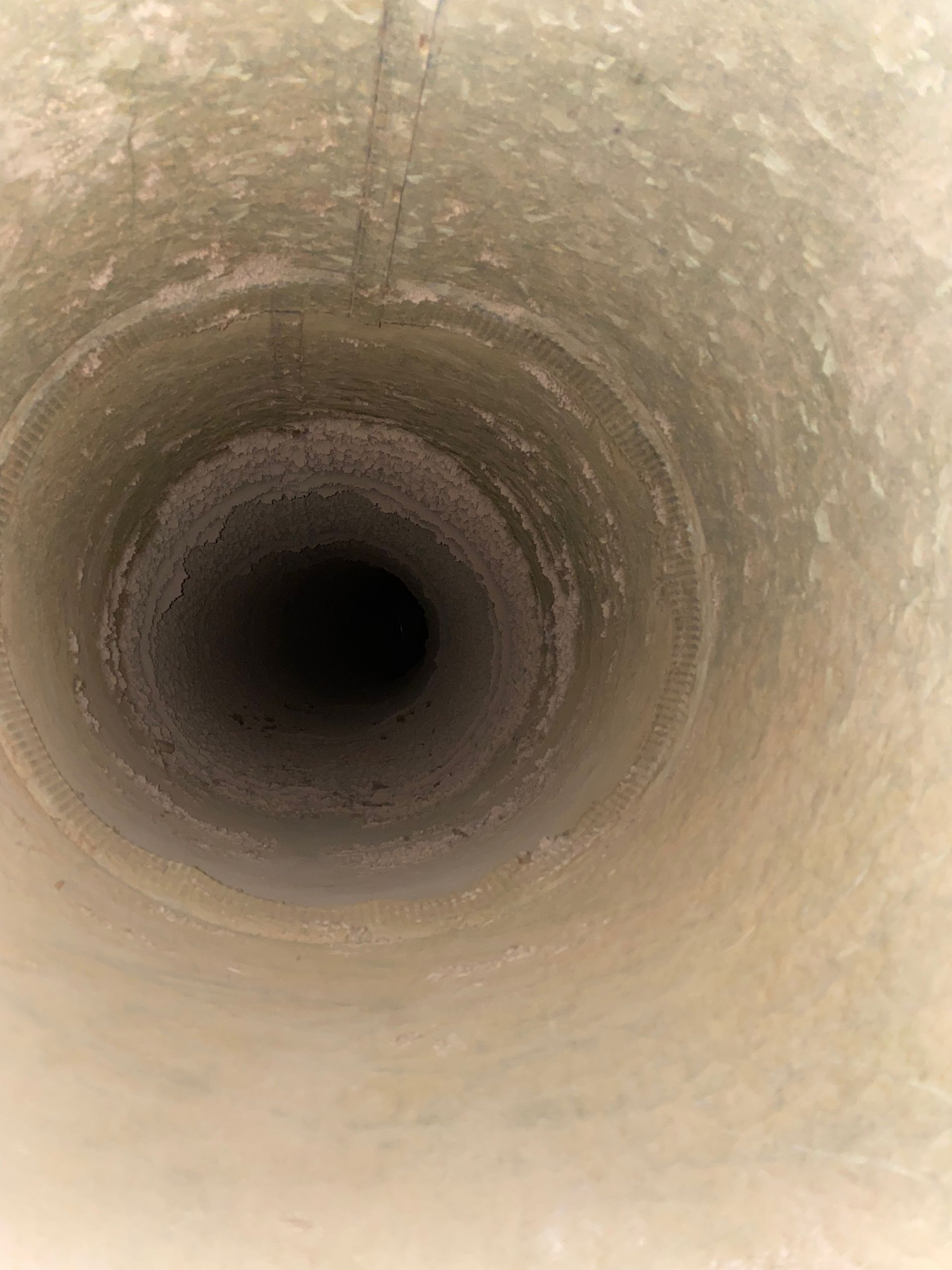 A close up of the inside of a drain pipe.
