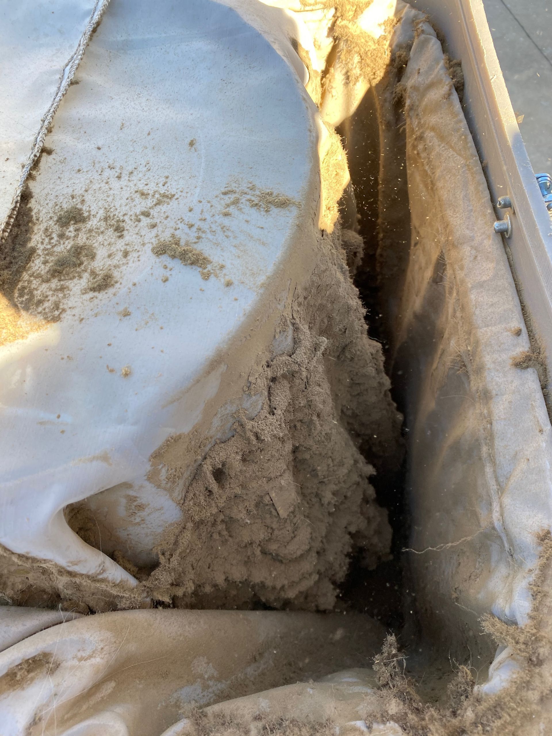 A large pile of sand is sitting on a white surface