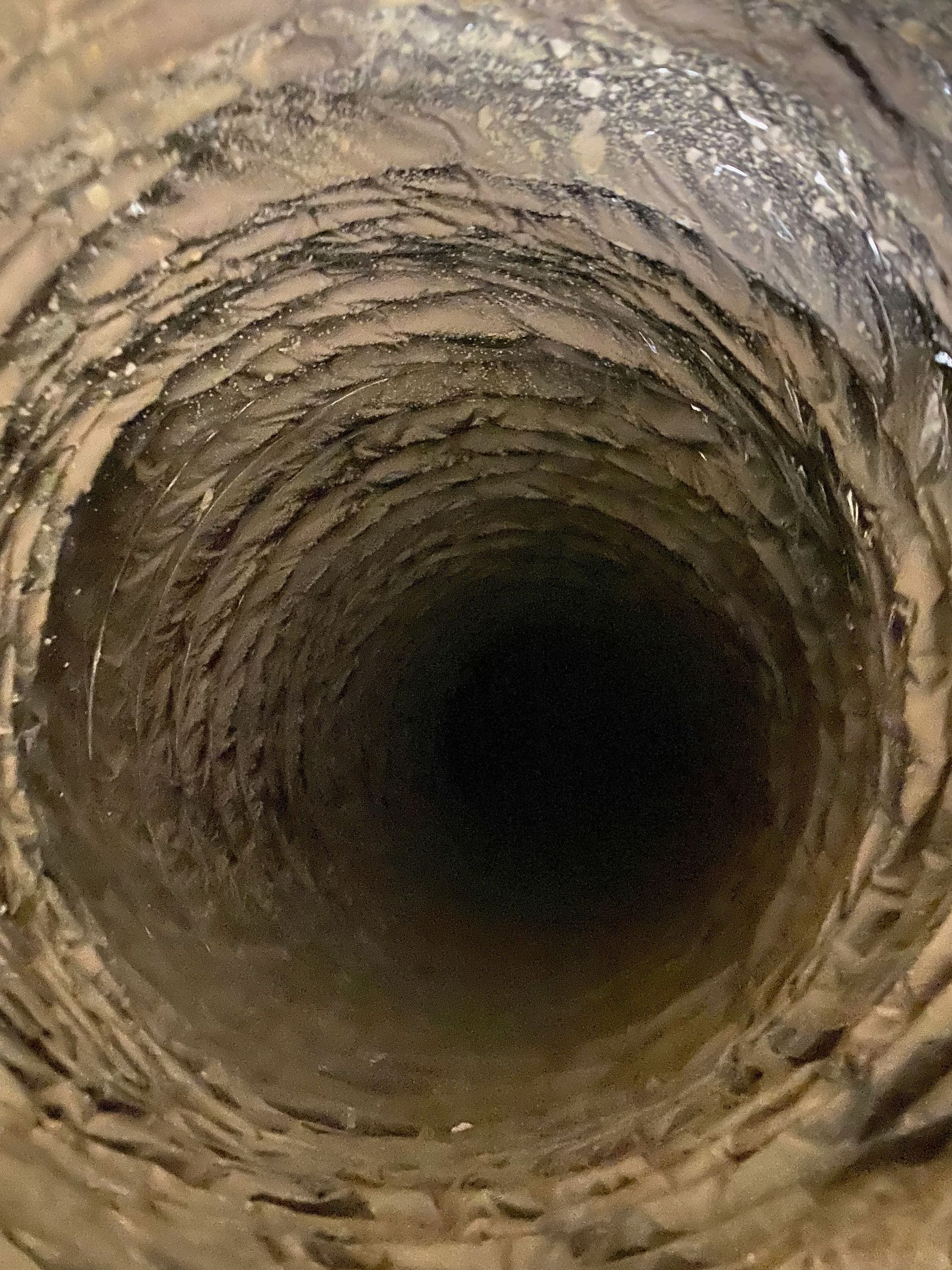 A close up of the inside of a drain pipe.