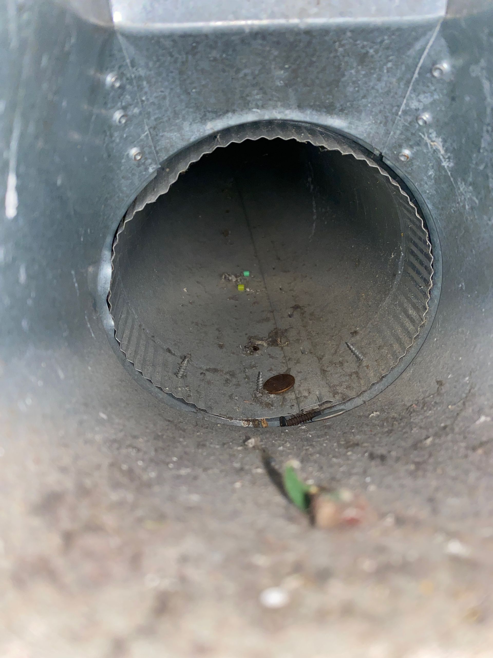 A close up of a metal pipe with a hole in the middle.