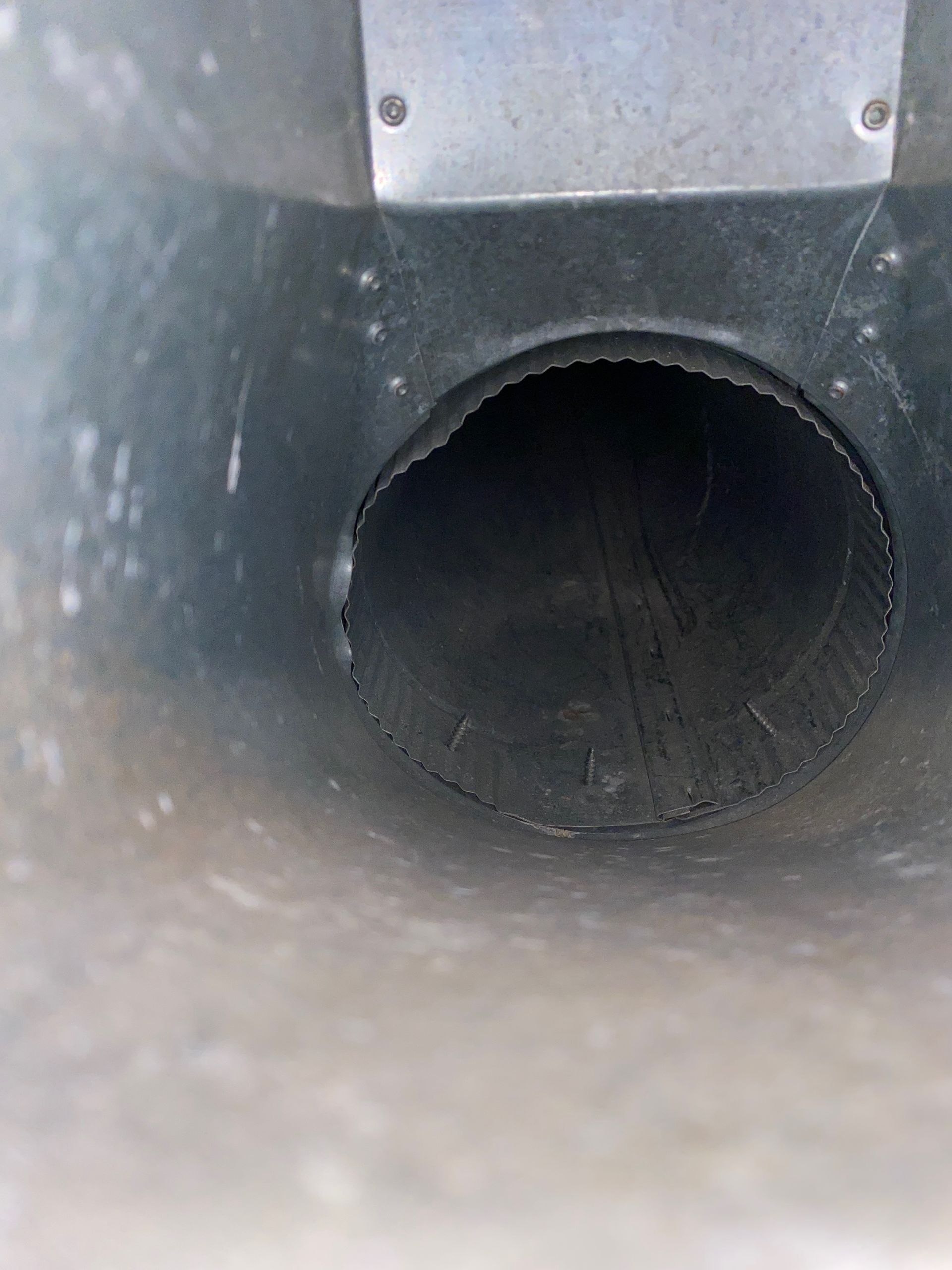 A close up of a metal pipe with a hole in the middle.