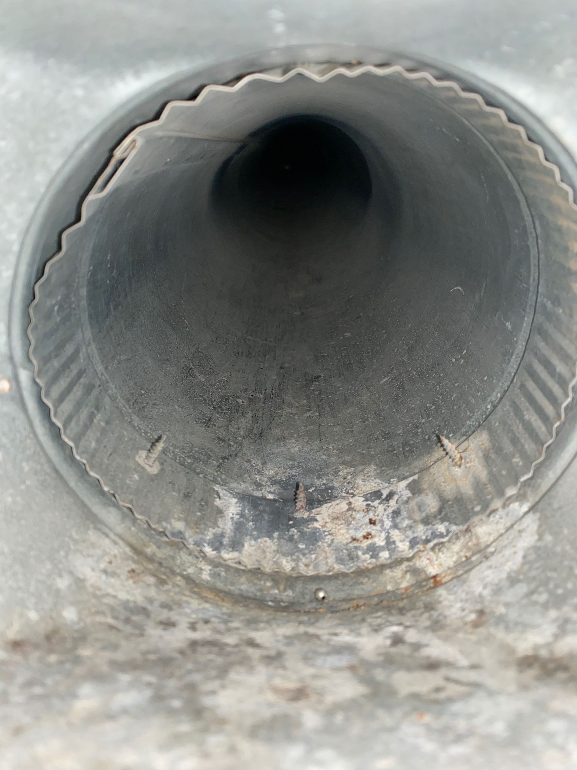 A close up of a metal pipe with a hole in the middle