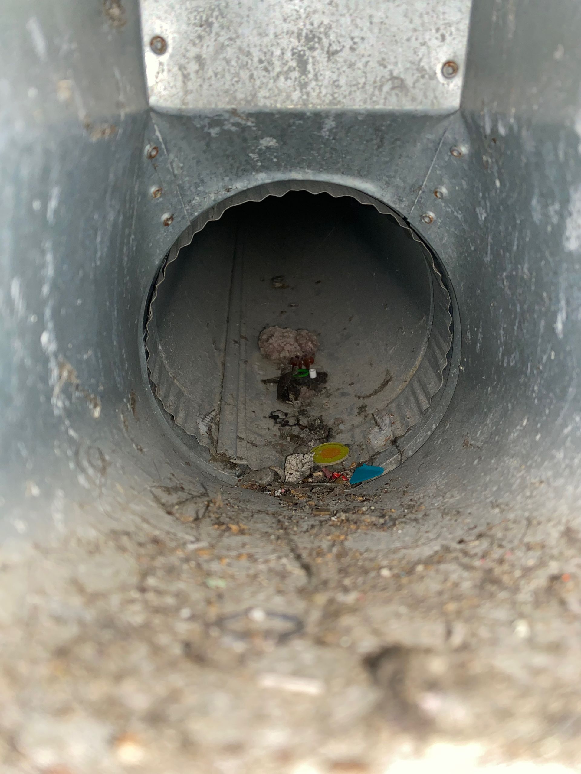 A close up of a metal pipe with a hole in it.