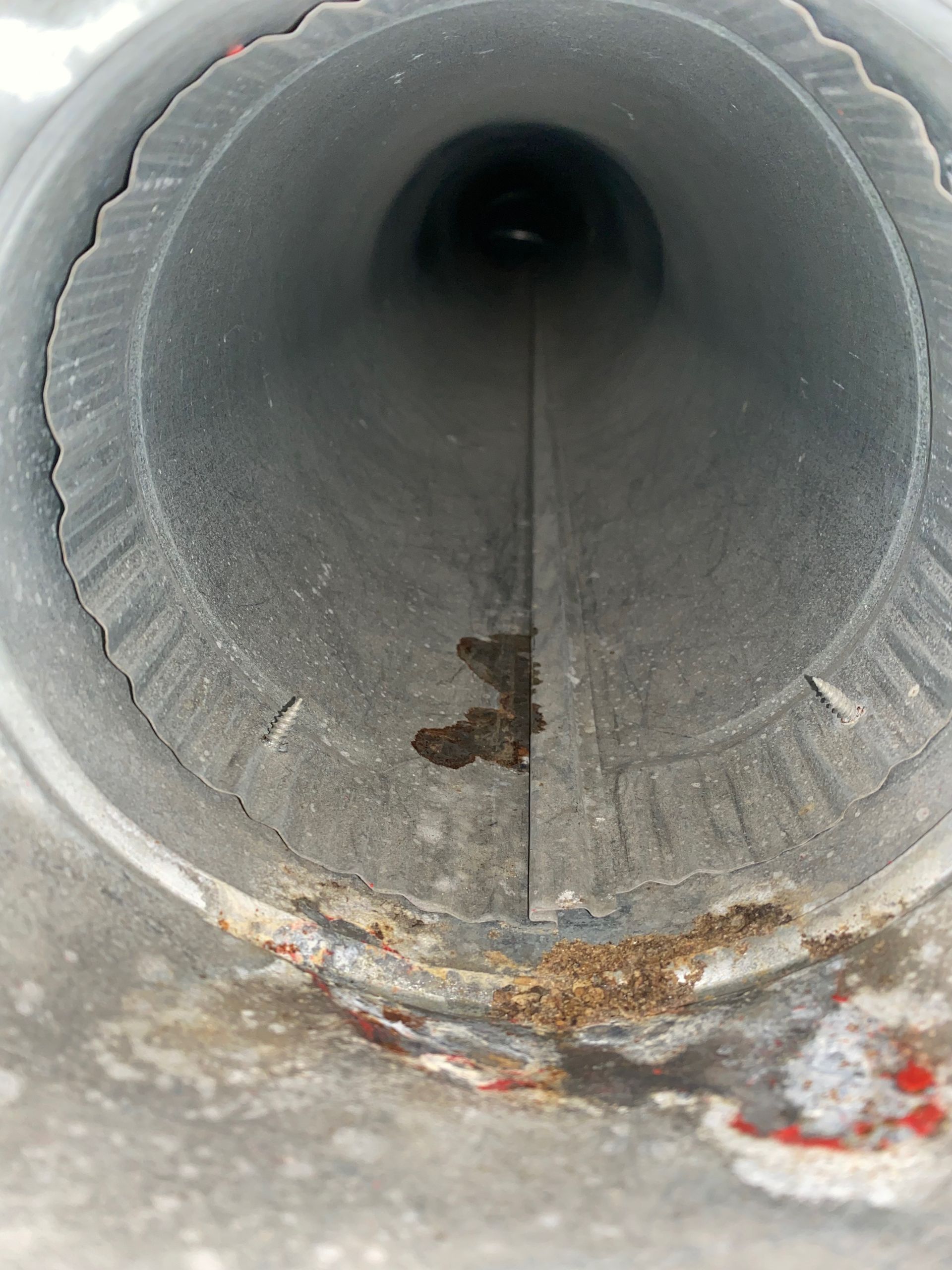 A close up of a metal pipe with a hole in the middle