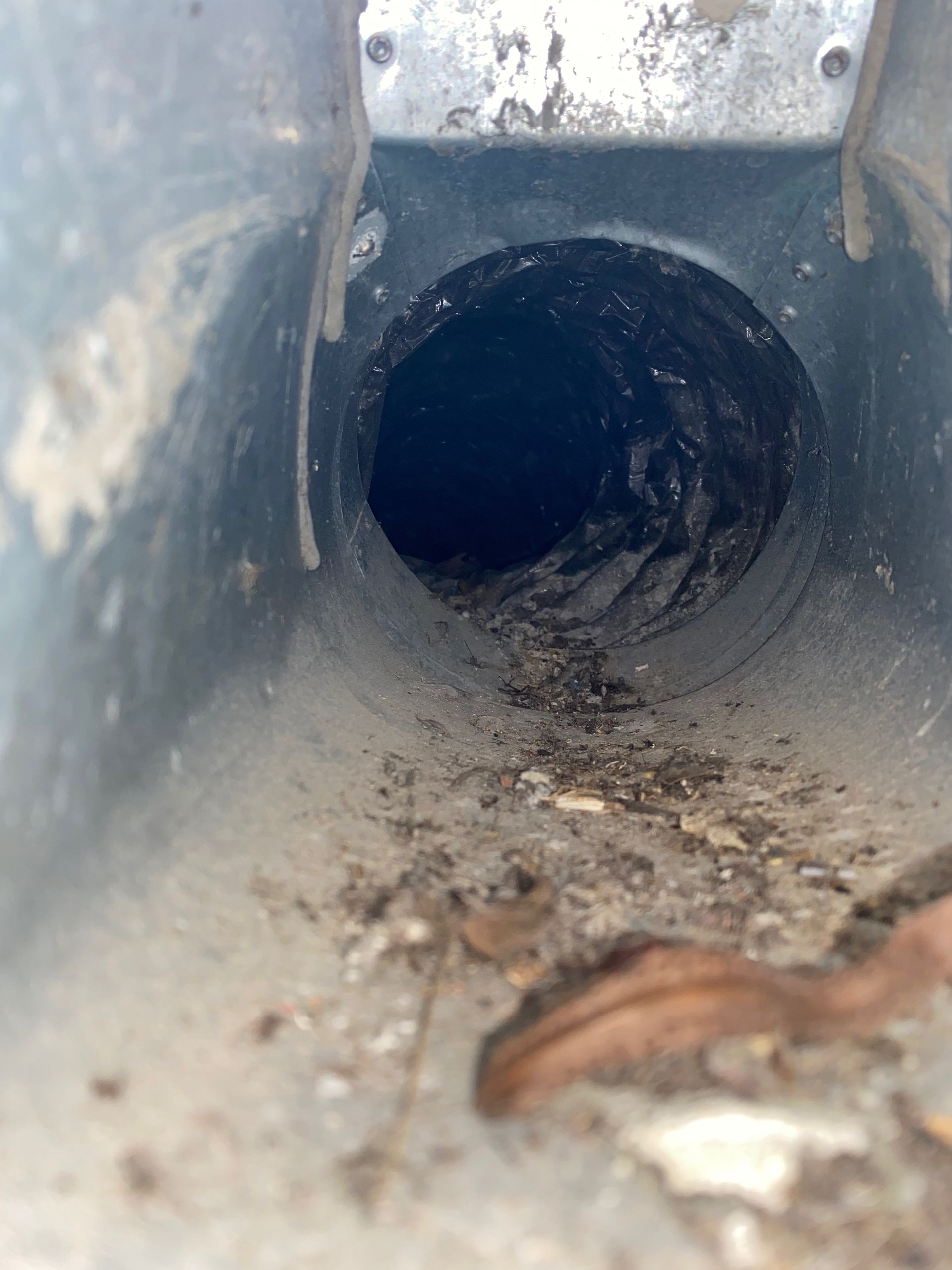 A close up of a metal pipe with a hole in the middle.