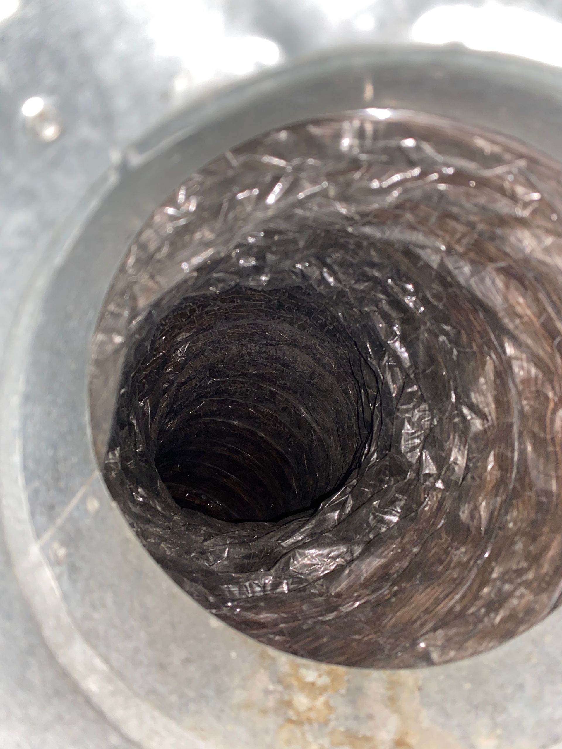A close up of a duct with a hole in it