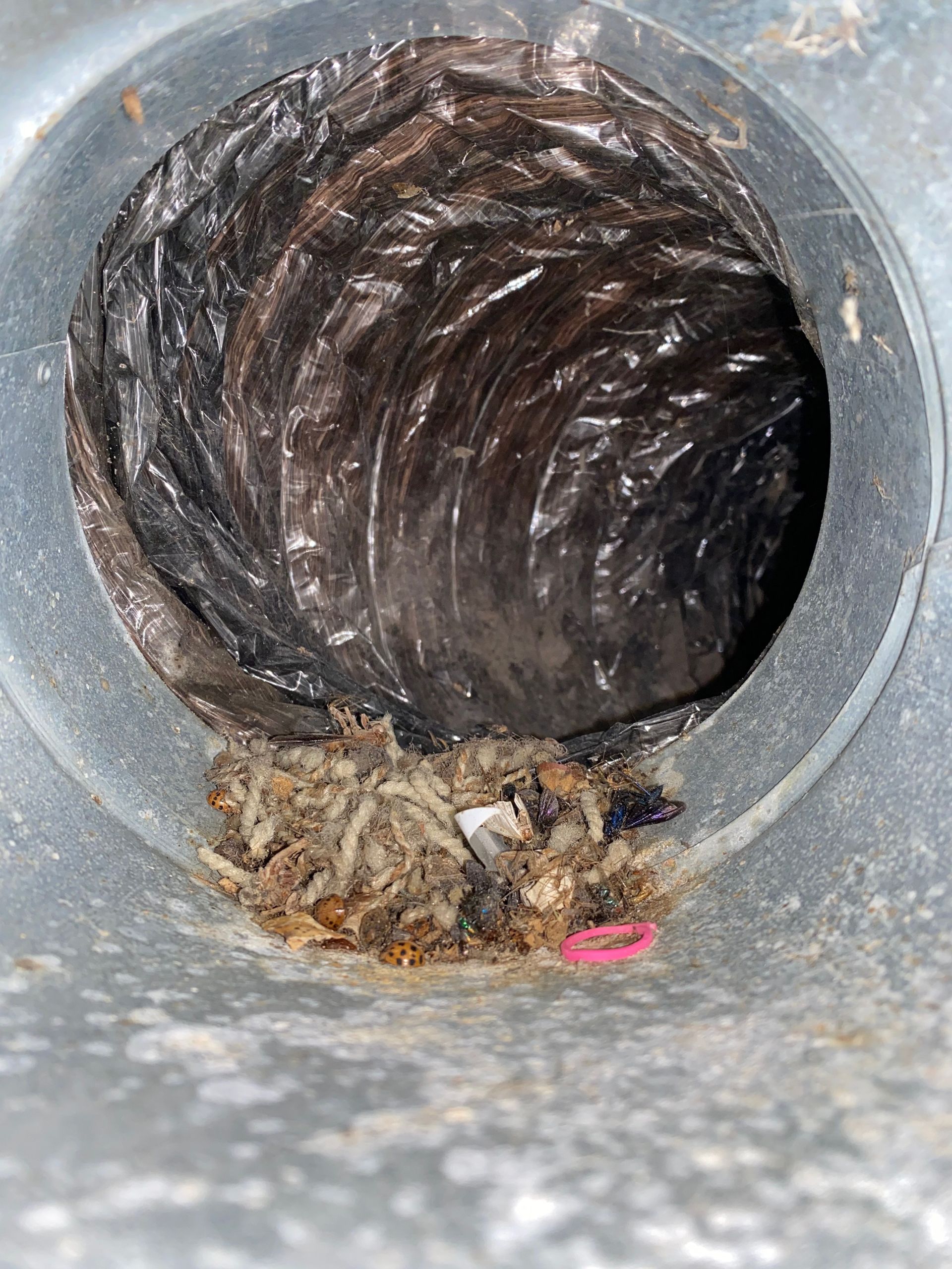 A close up of a hole in a metal pipe