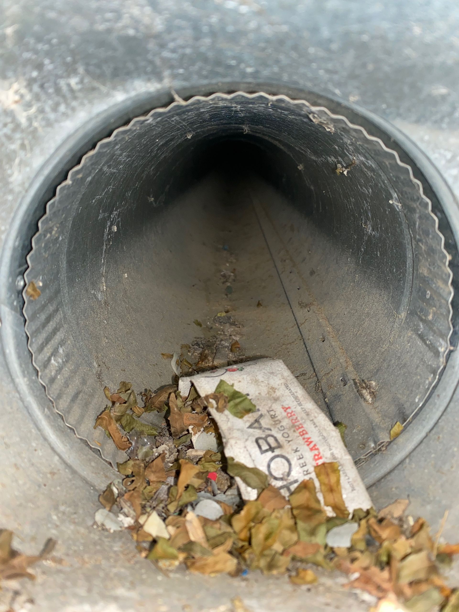 A garbage can with a piece of paper that says ' acorn ' on it