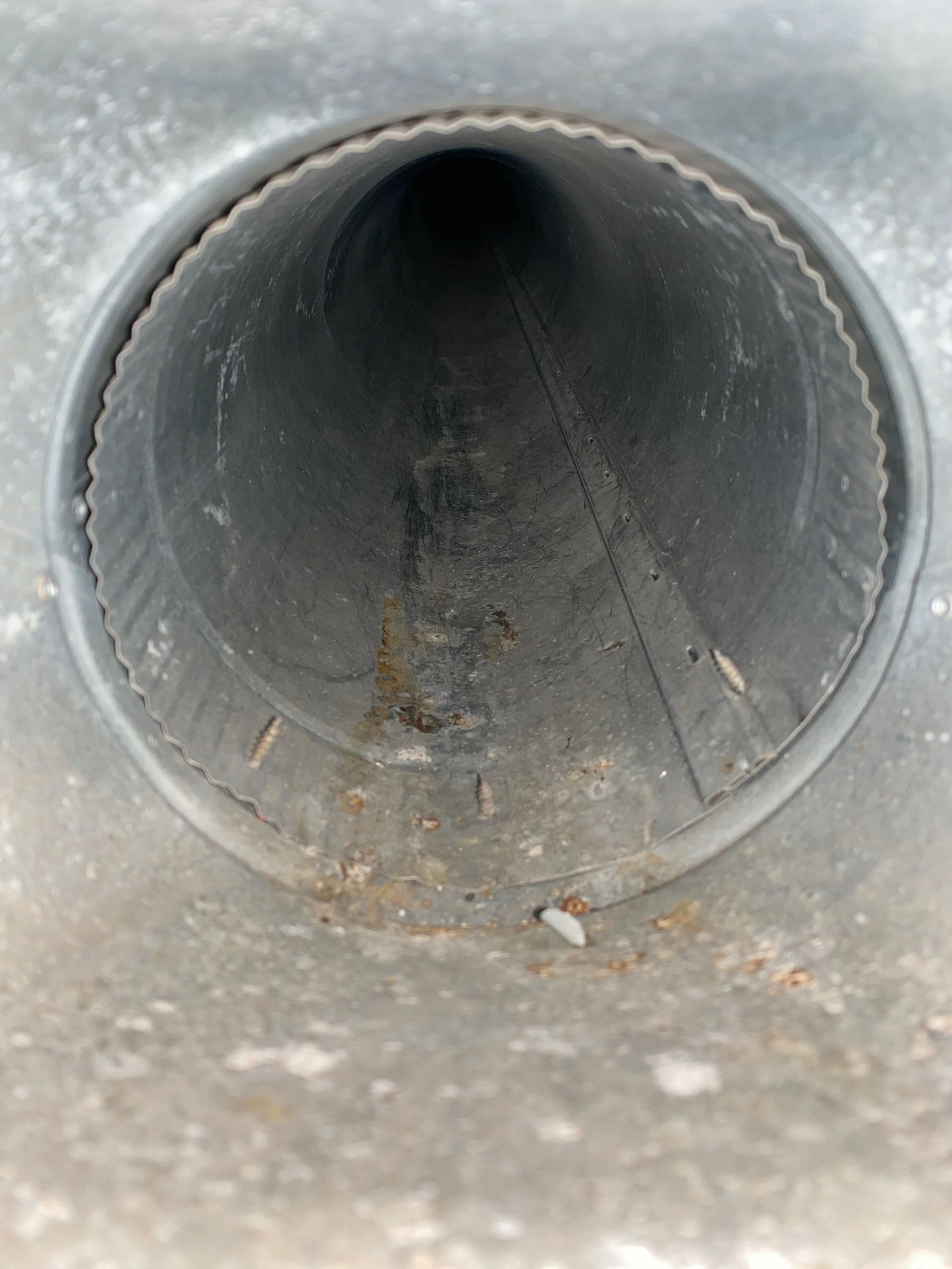 A close up of a metal pipe with a hole in the middle