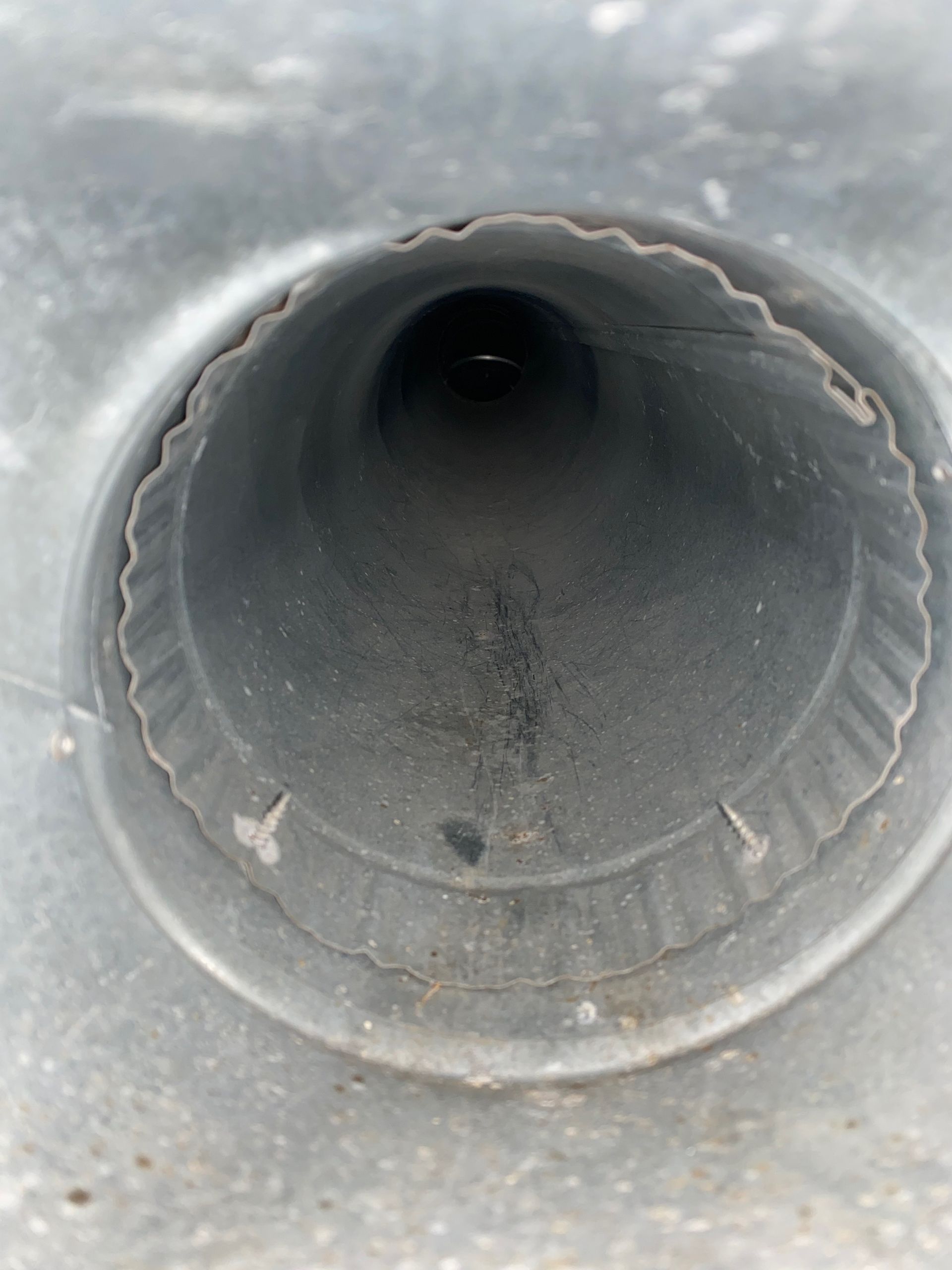 A close up of a metal pipe with a hole in the middle